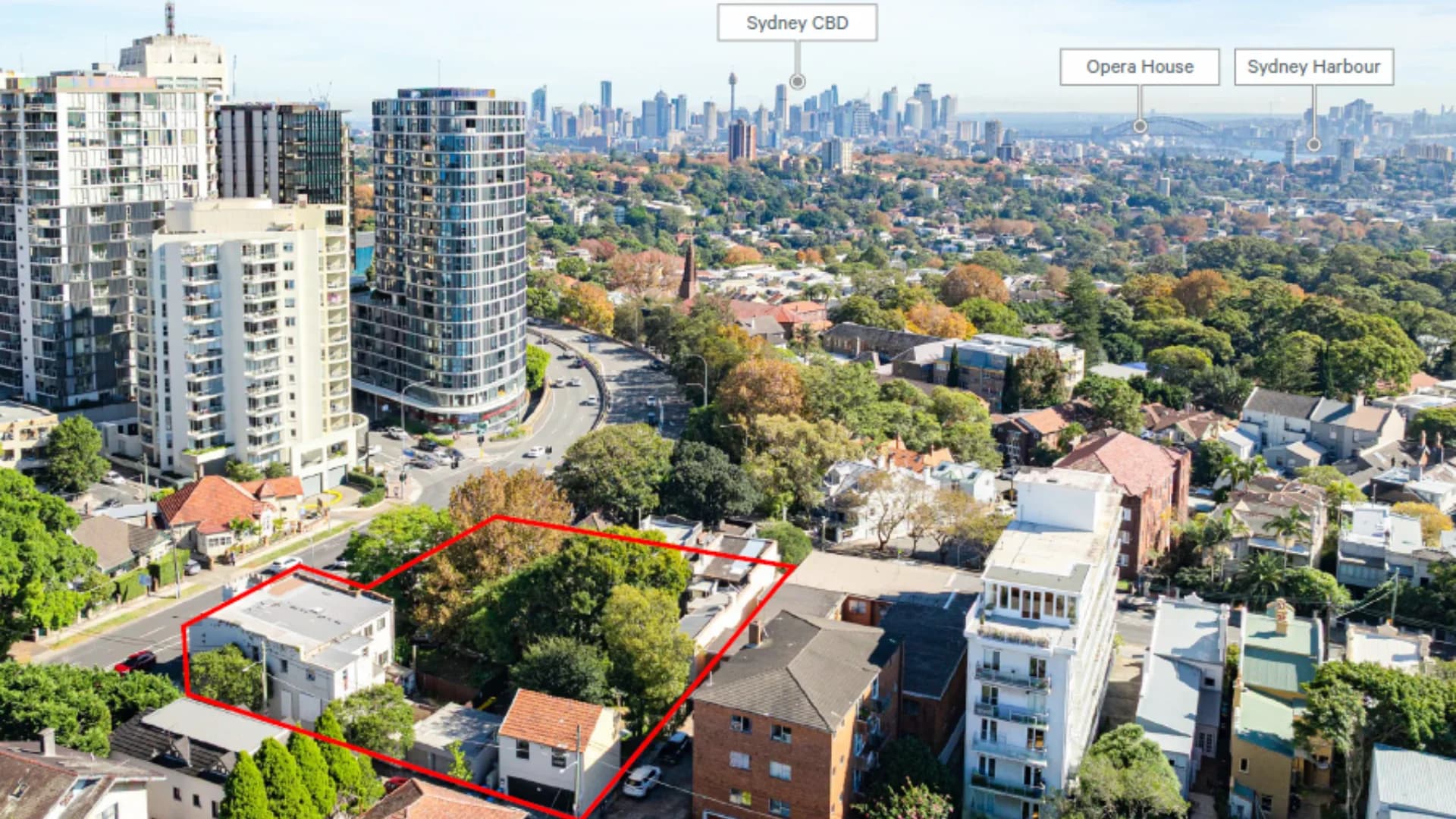 Aerial view of the Bondi Junction site at the intersection of Bondi Road and Old South Head Road, with Sydney CBD, Opera House and Harbour in the background
